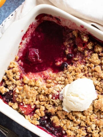 Frozen berry crumble in a pie dish.