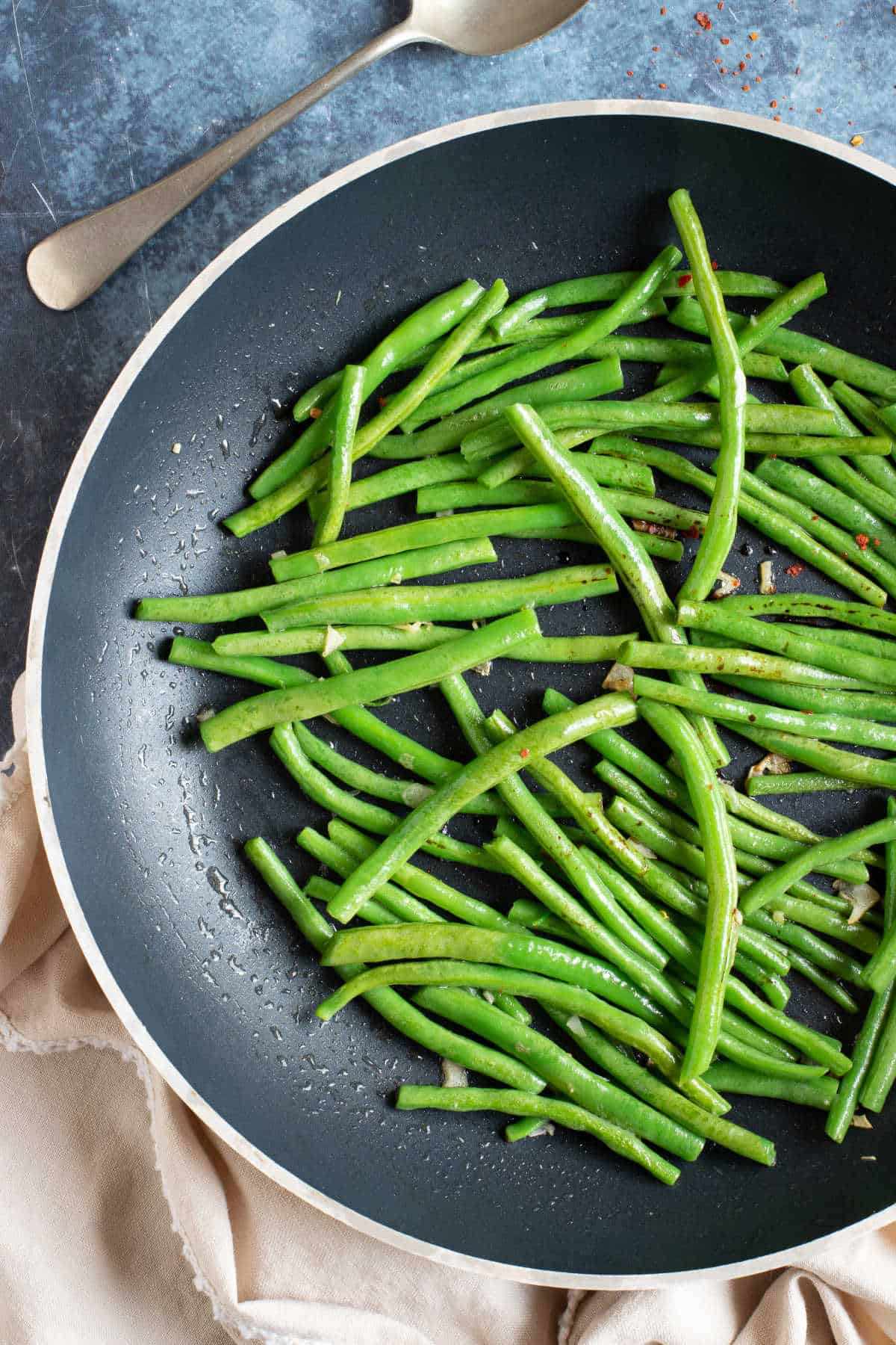 Stir fried green beans in a wok.