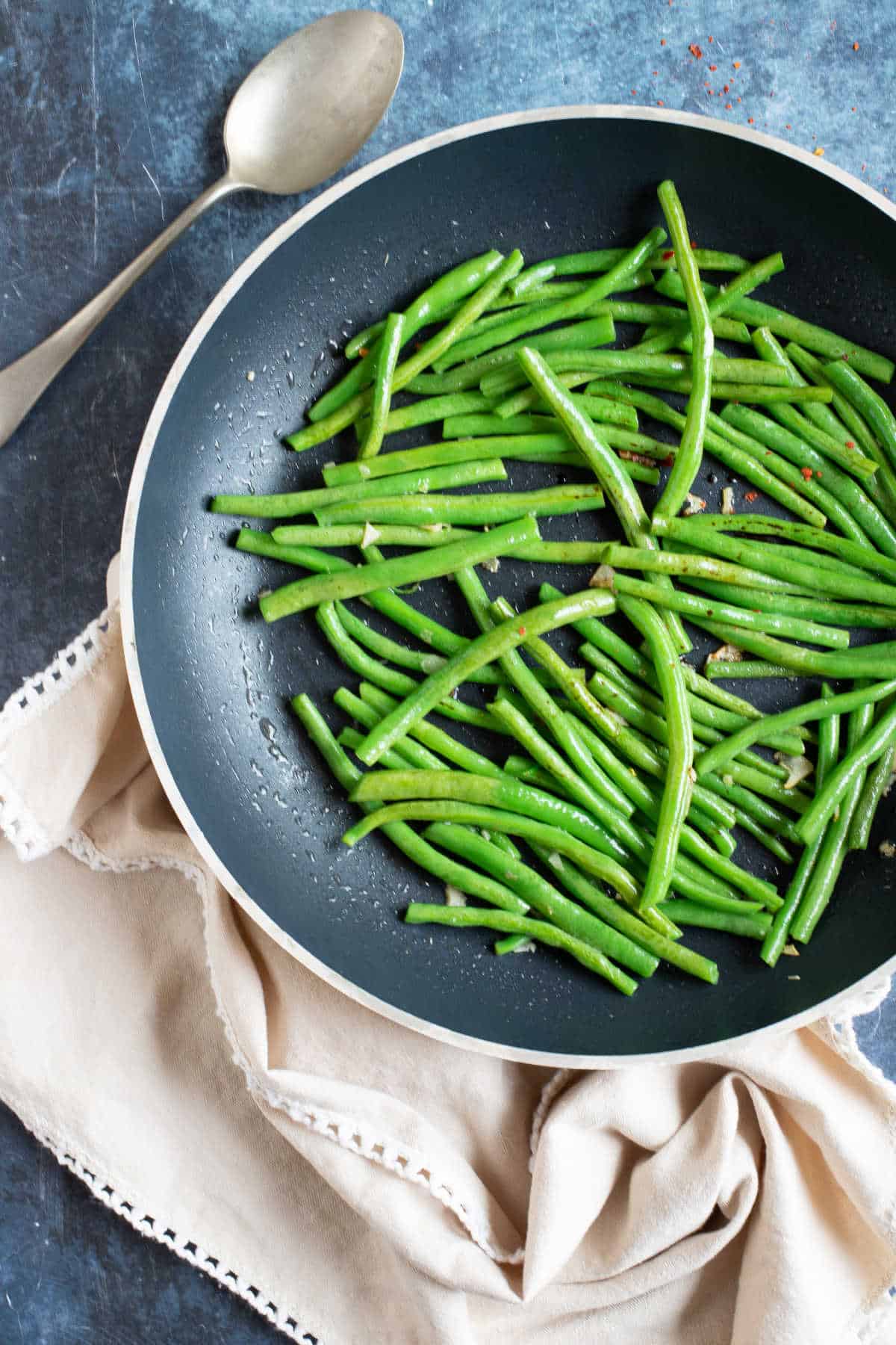 Green beans in a black wok.