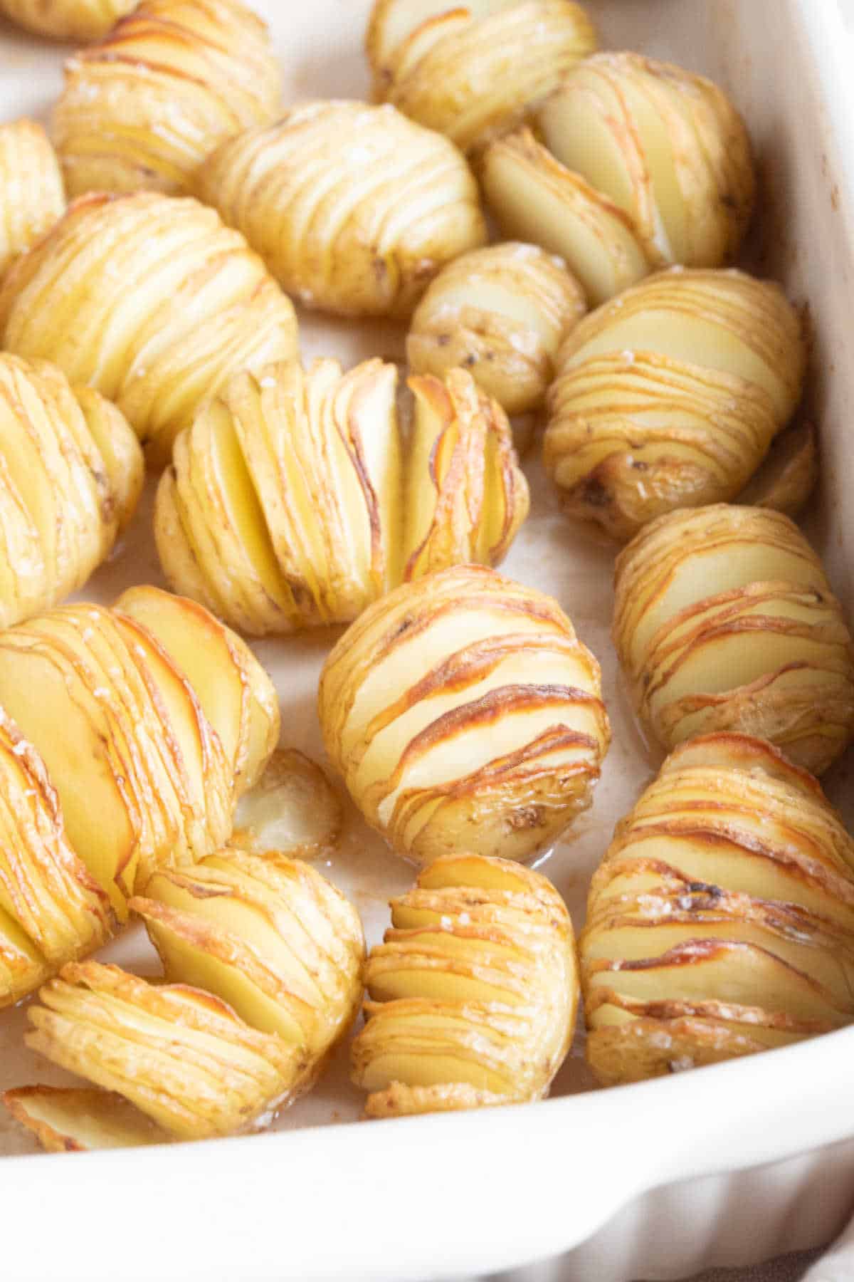 Hasselback potatoes in baking dish.