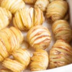 Mini hasselback potatoes in a baking tray.