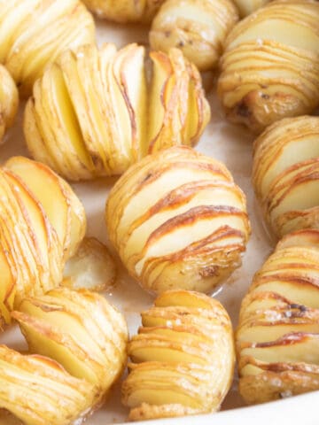 Mini hasselback potatoes in a baking tray.