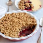 Blackberry and apple crumble in a red pie dish.