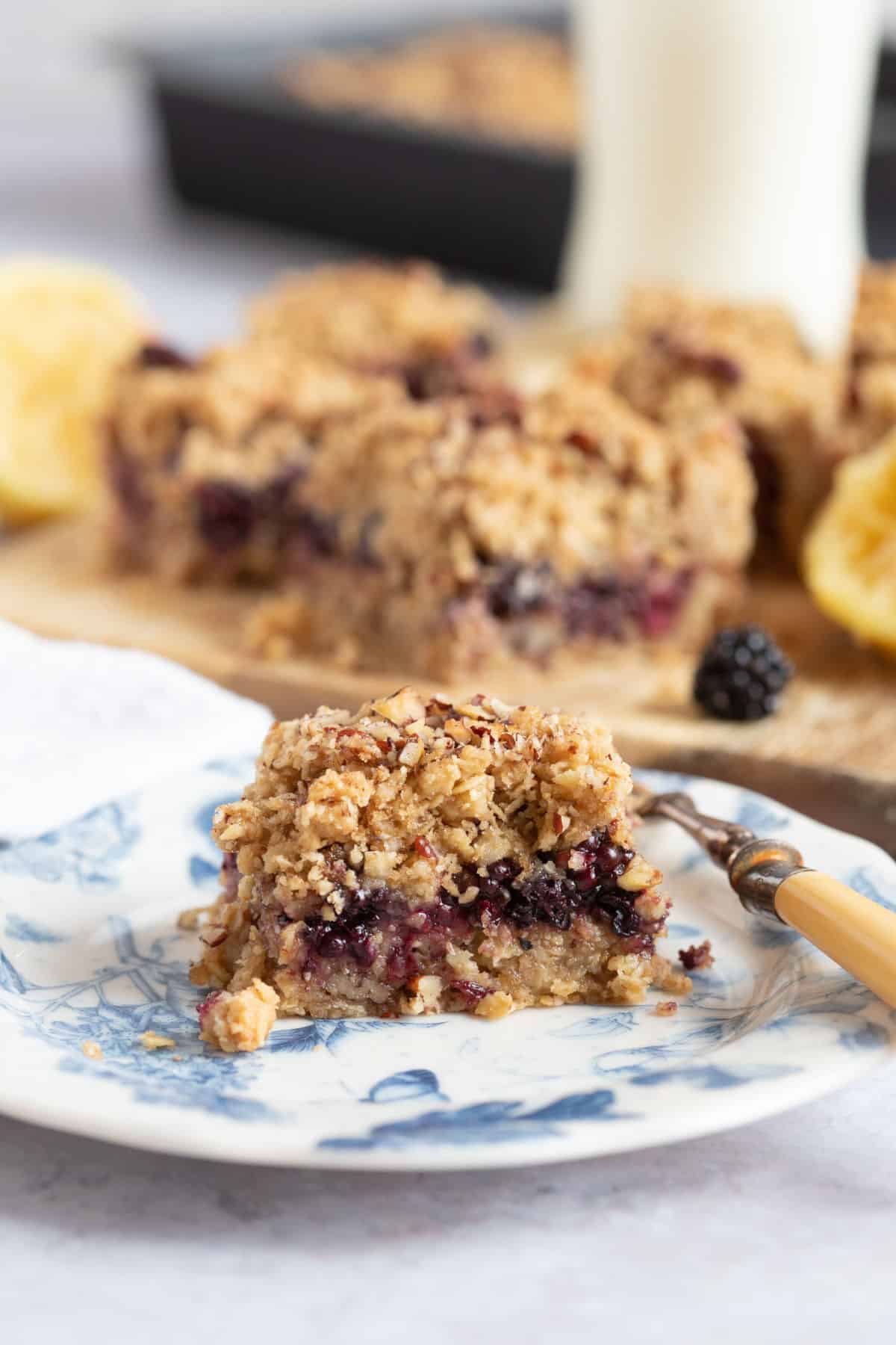 Blackberry crumble bar on a blue and white plate.