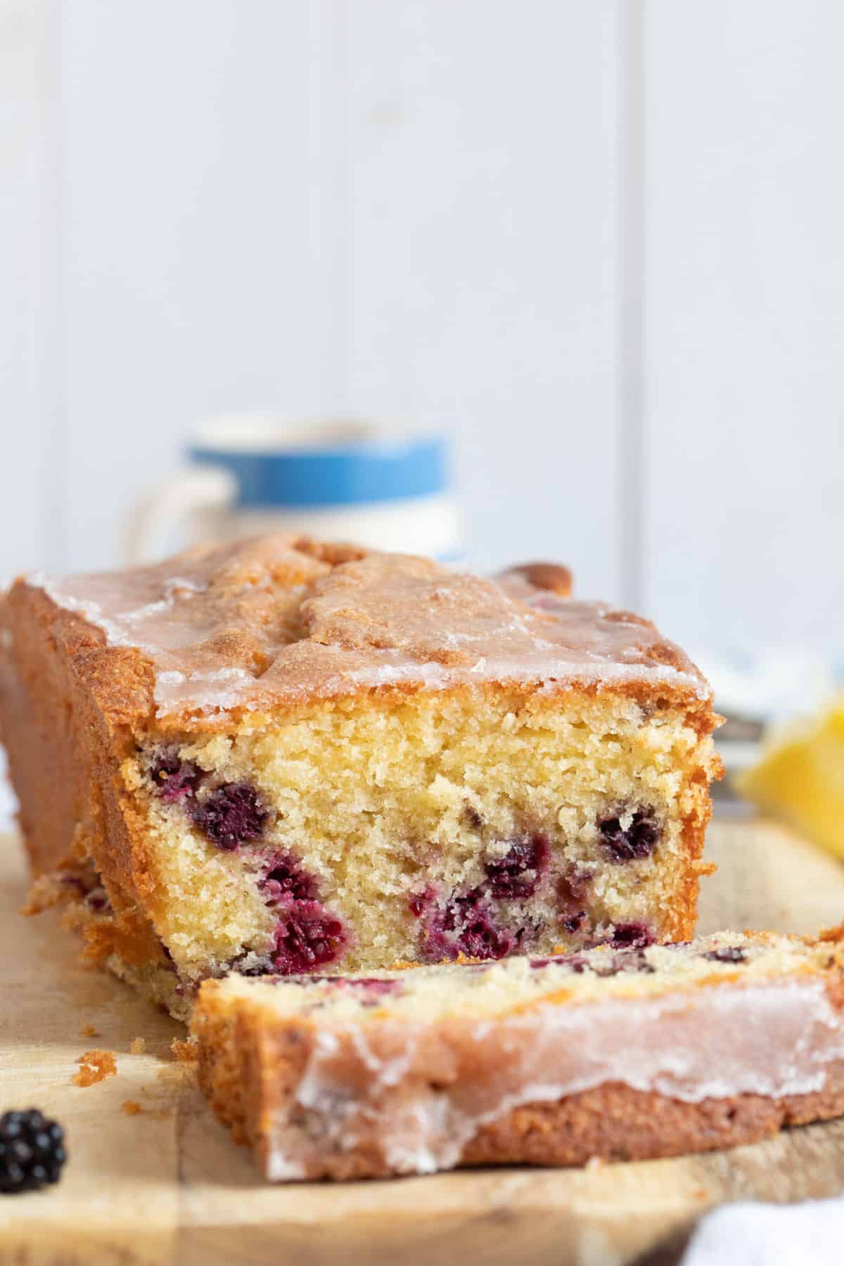 Blackberry loaf cake on a wooden board.