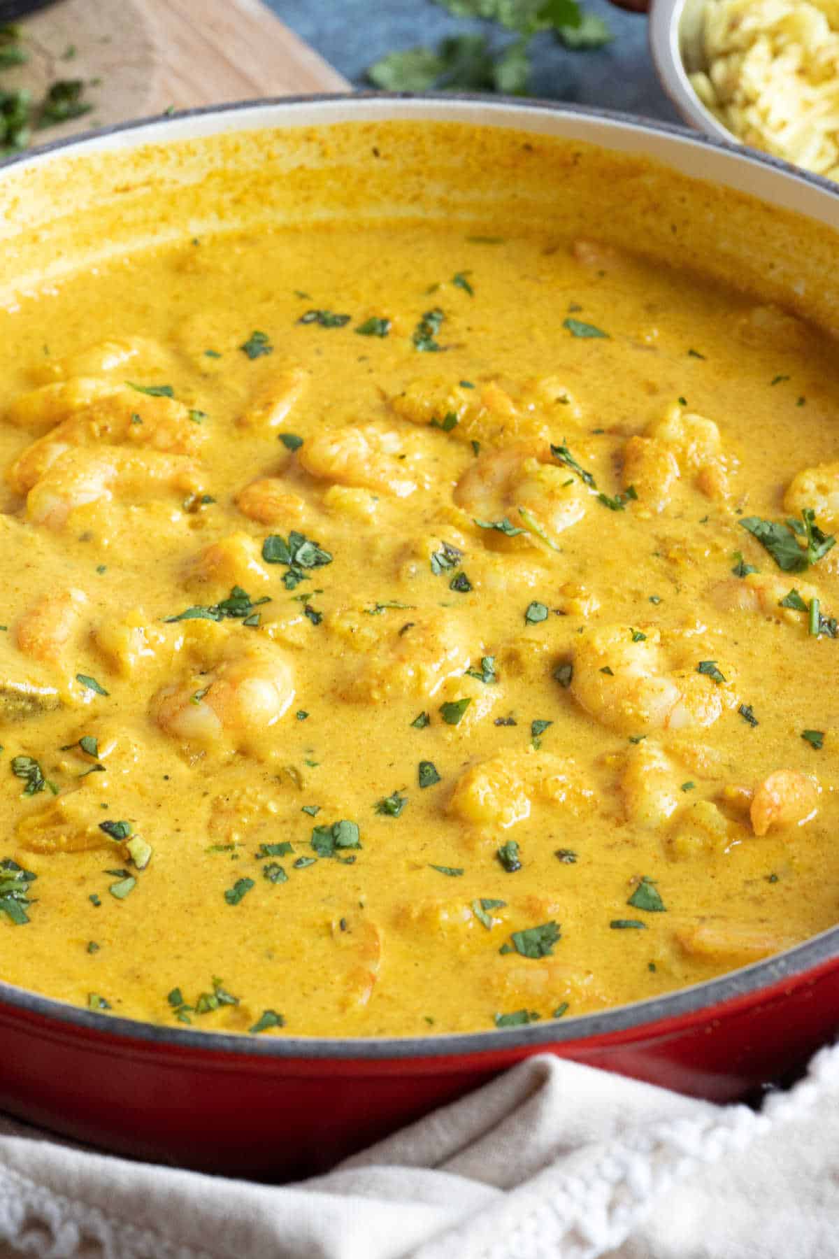 Prawn korma curry garnished with coriander.