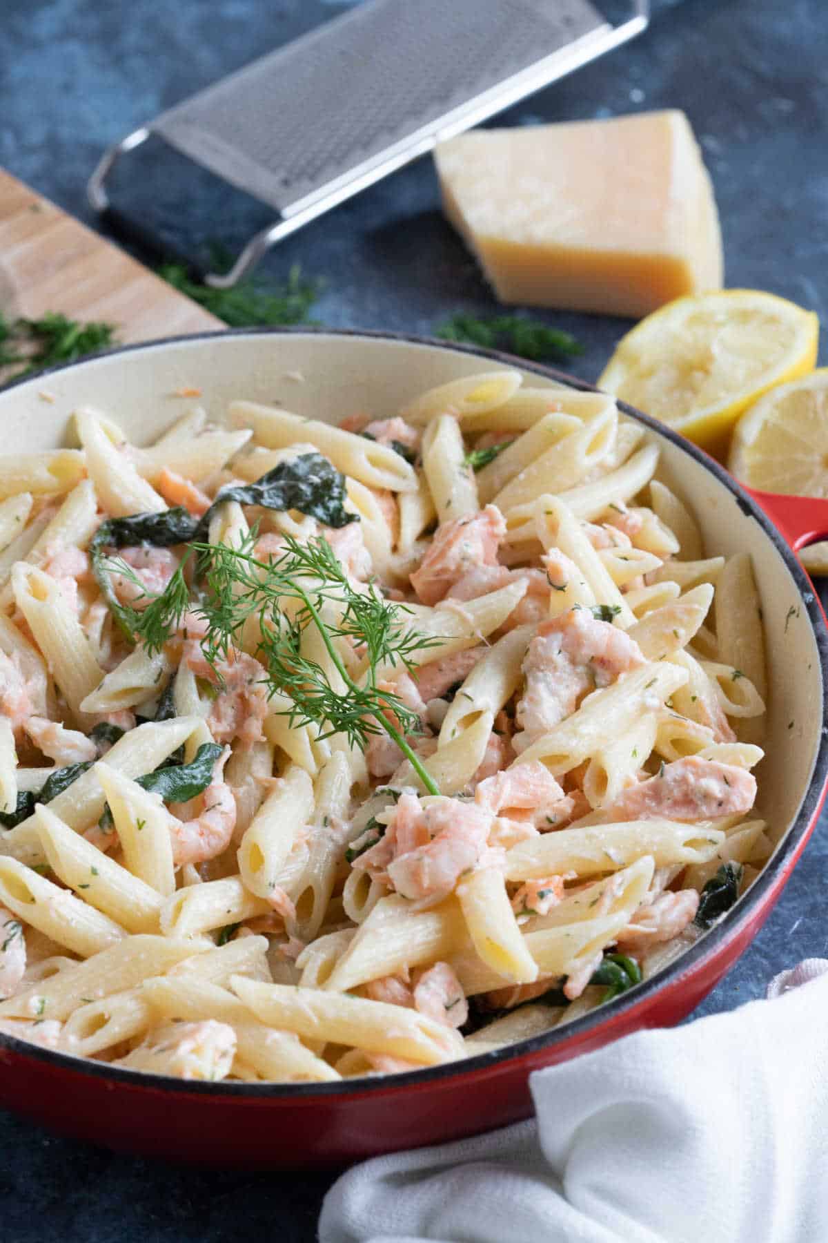 Easy prawn and salmon pasta garnished with dill and lemon.