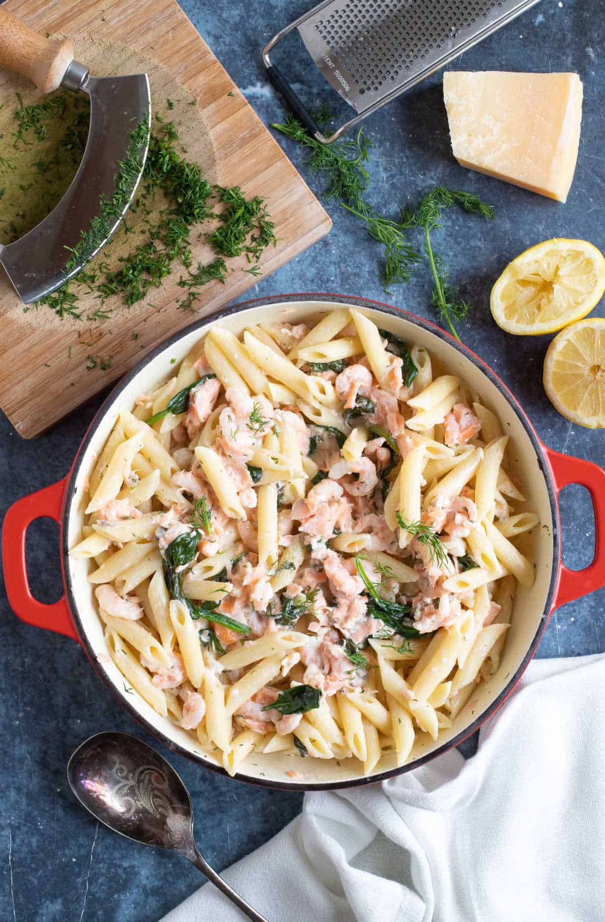 Hot smoked salmon and prawn pasta in a serving dish.