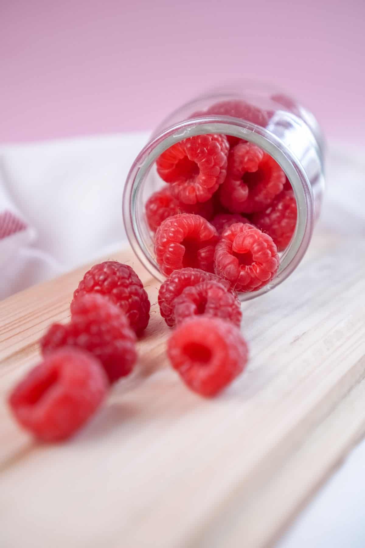 A jar of fresh raspberries.