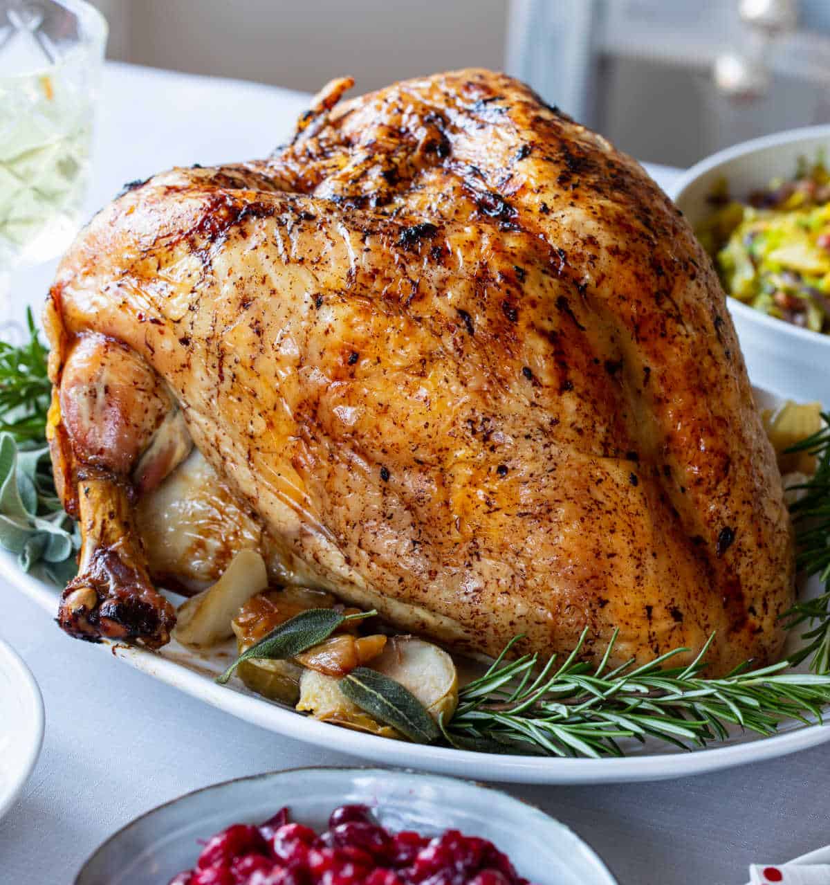 Slow cooker turkey crown on a white platter.