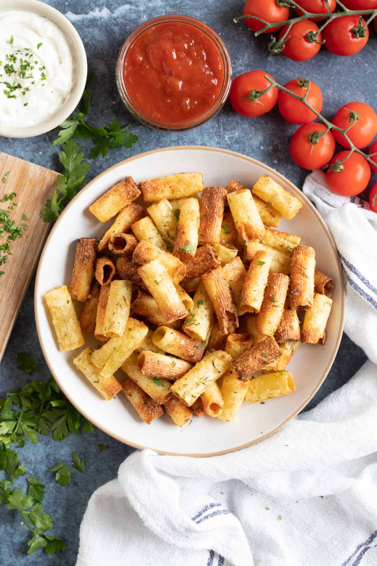 Pasta chips on a plate with salsa sip.