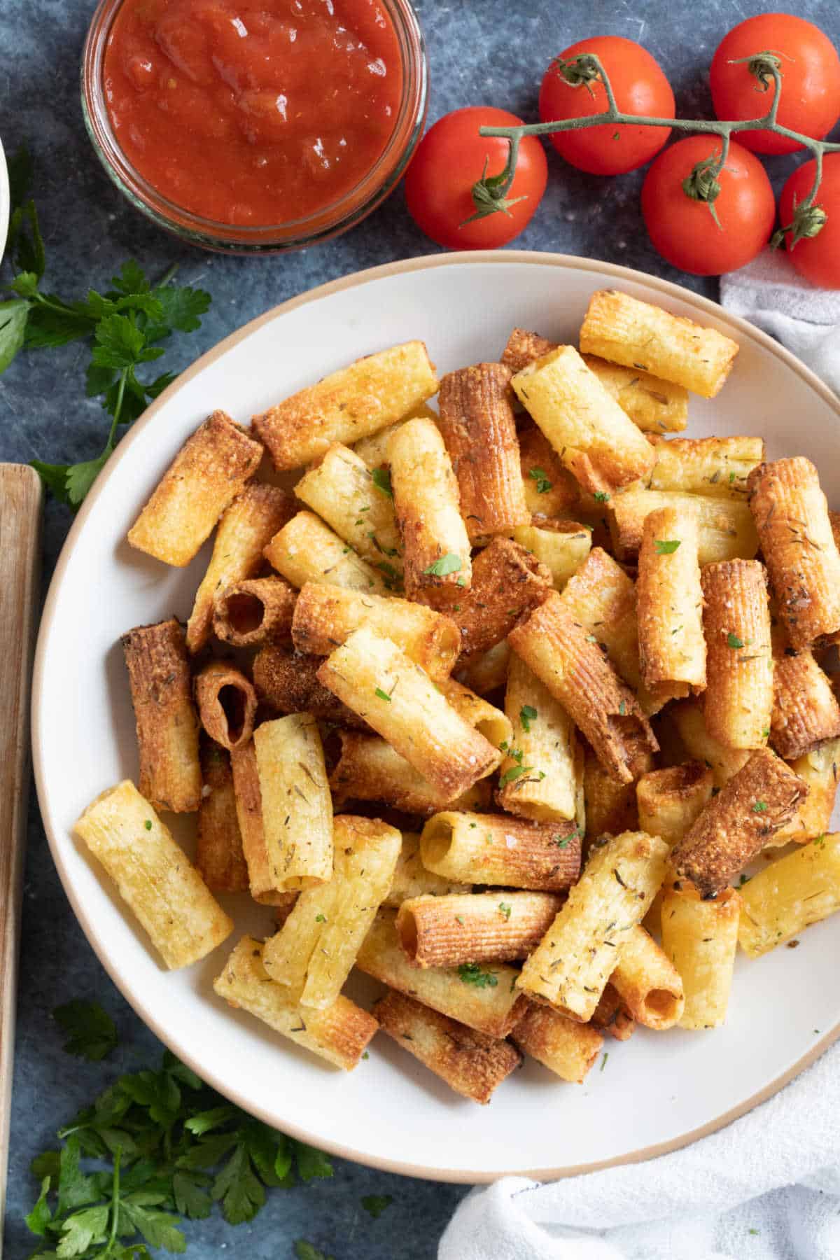 Air fryer pasta chips on a plate with salsa dip.