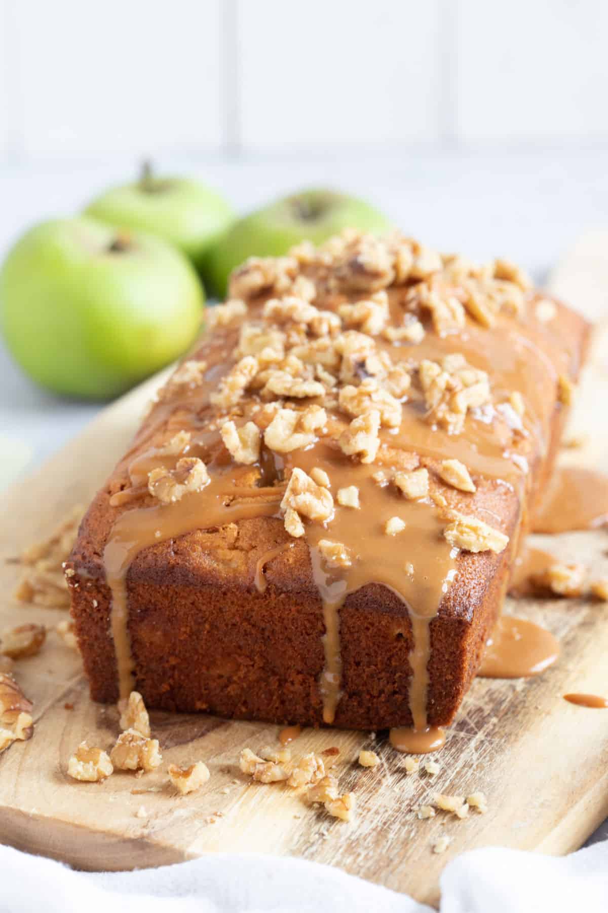 Apple loaf cake on a wooden board.