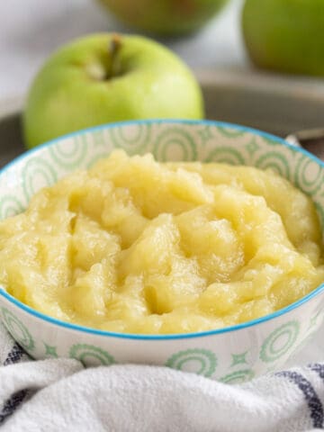 Homemade apple sauce in a blue and white bowl.