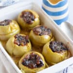 Baked apples with mincemeat in a baking dish.