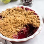 Blackcurrant crumble in a pie dish.