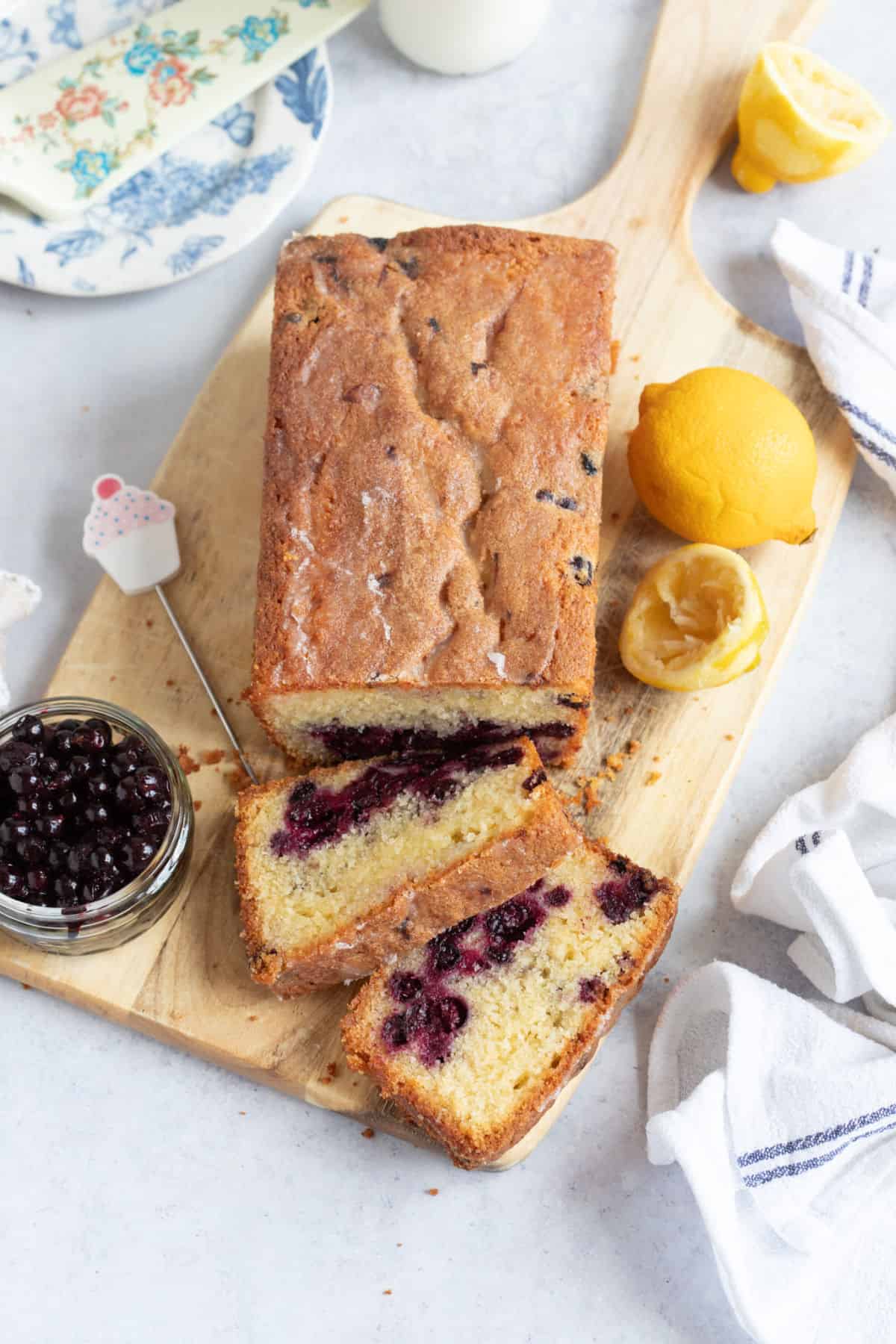 Blackcurrant loaf cake on a wooden board.