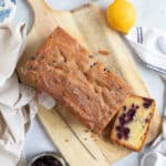 Blackcurrant loaf cake with a slice cut off.