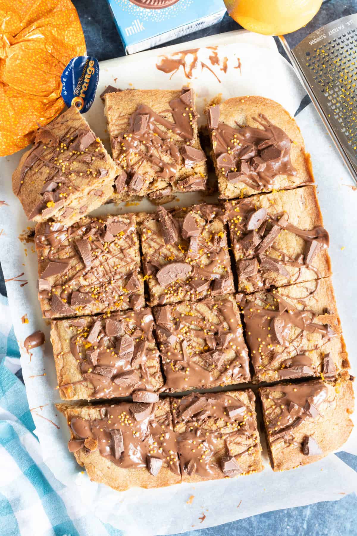 Chocolate orange cookie bars on a wooden board.