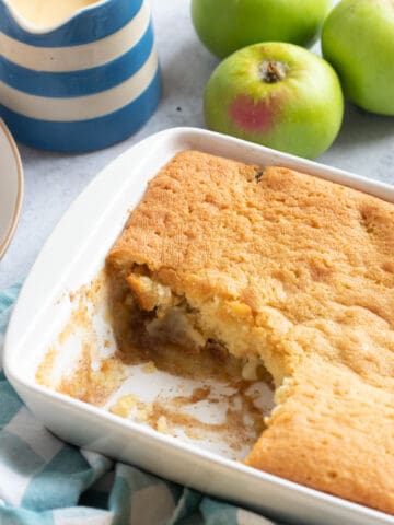 Eve's pudding in a white baking dish.