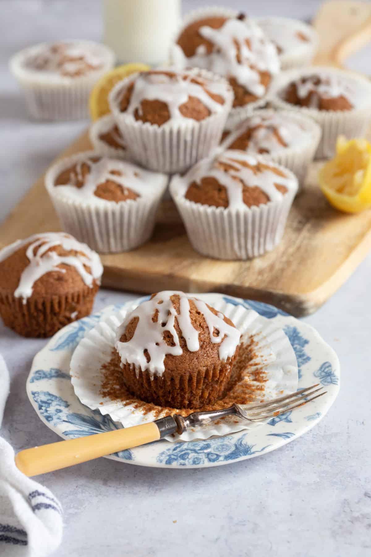 A gingerbread muffin on a plate with gingerbread muffins in the background.