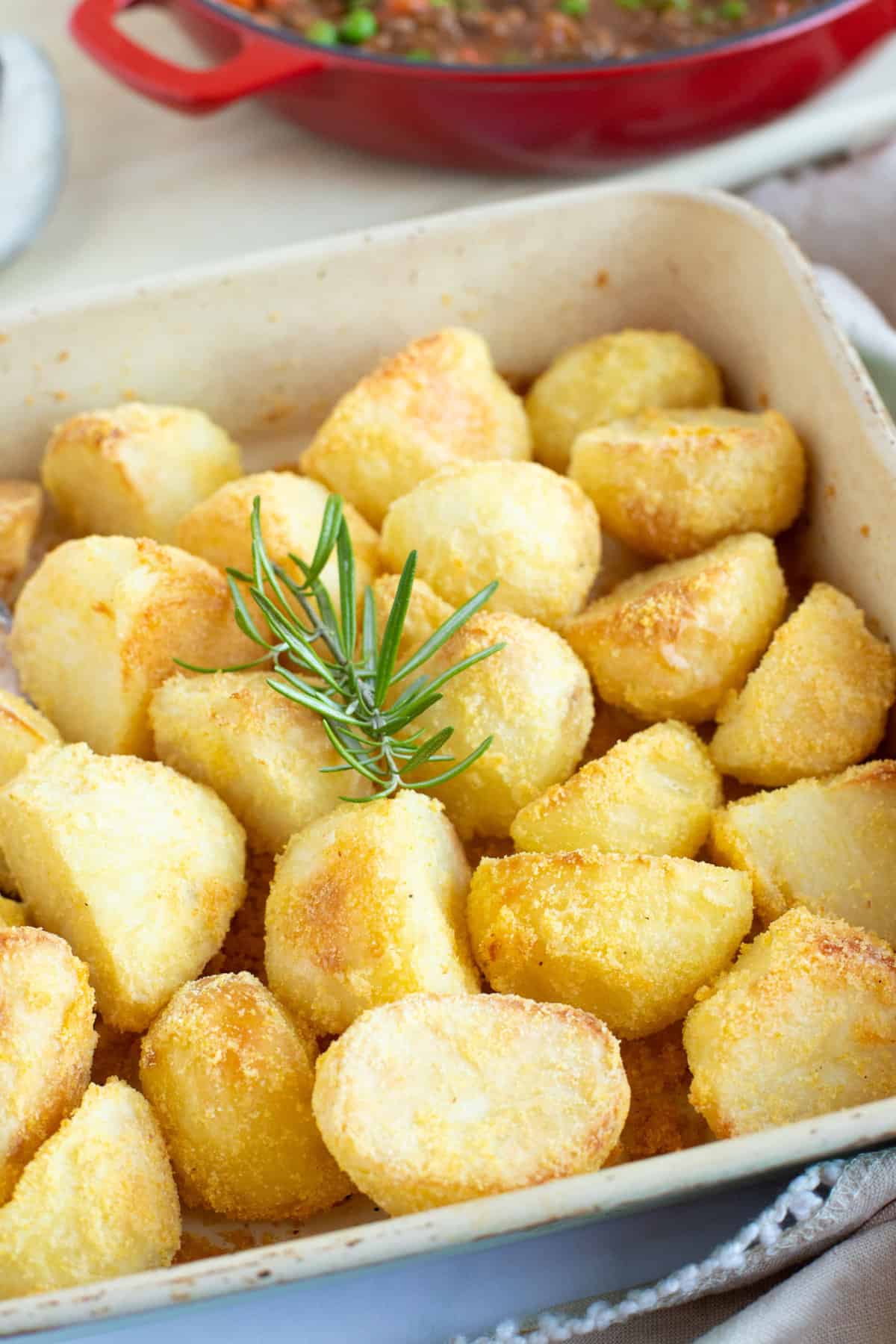 Polenta roast potatoes in a roasting tin.