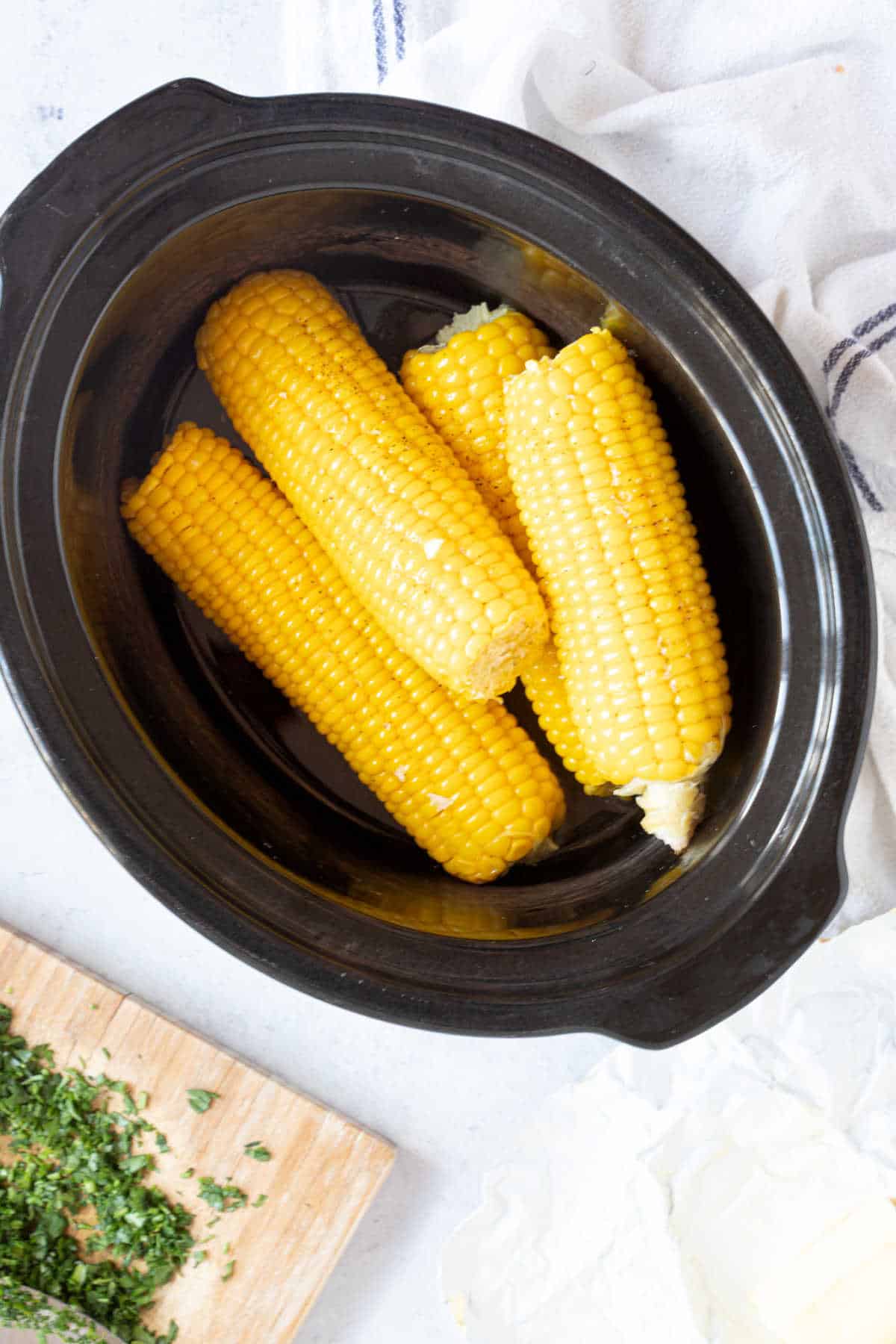 Slow cooker corn in a black slow cooker basin.