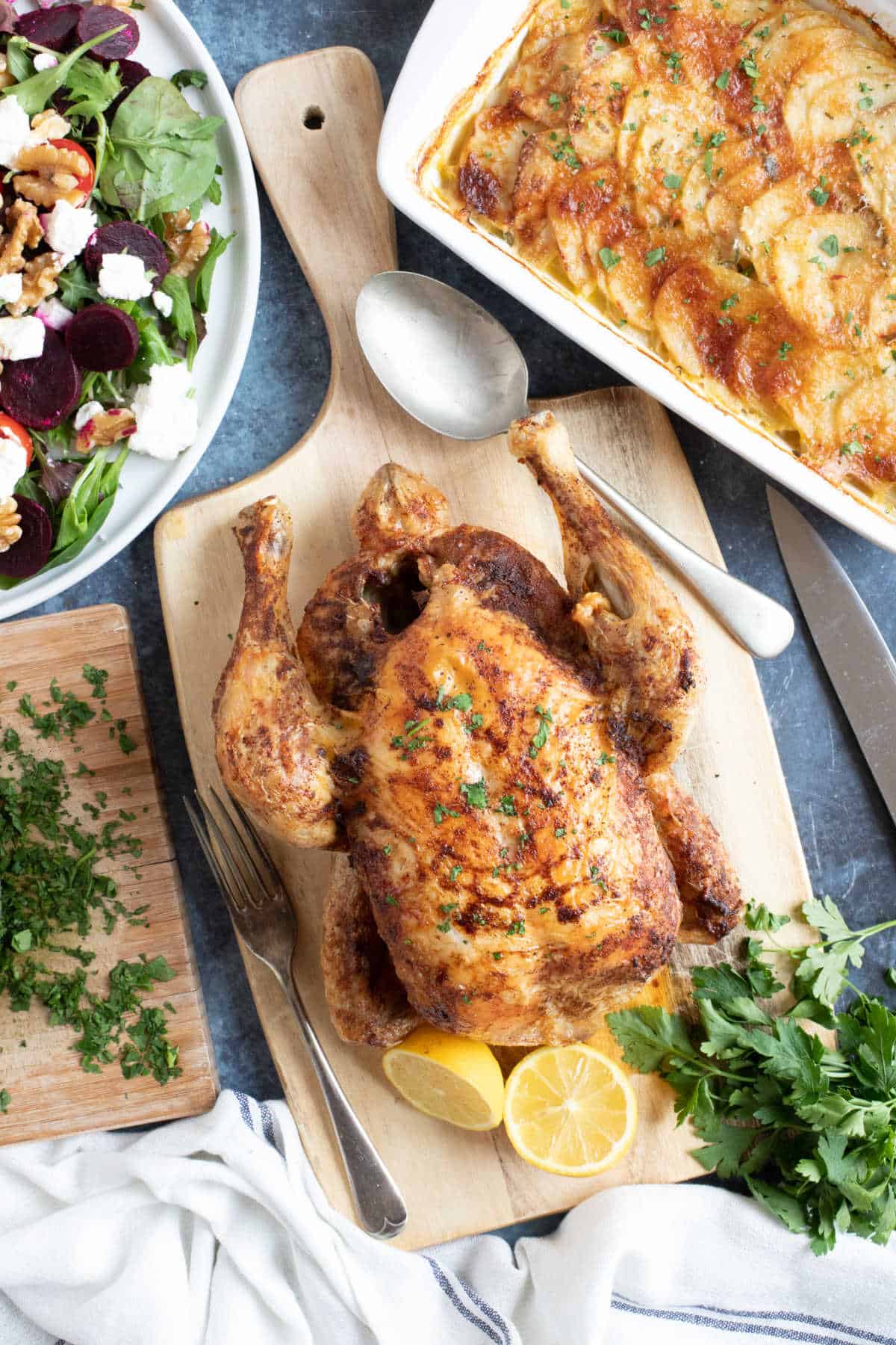 Slow cooker whole chicken on a wooden board.