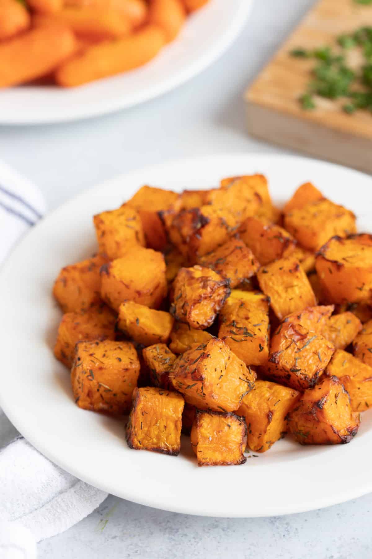 Air fried butternut squash cubes on a plate.