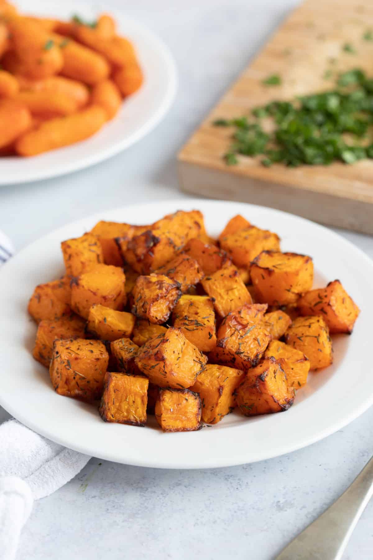 Air fryer butternut squash on a white plate.