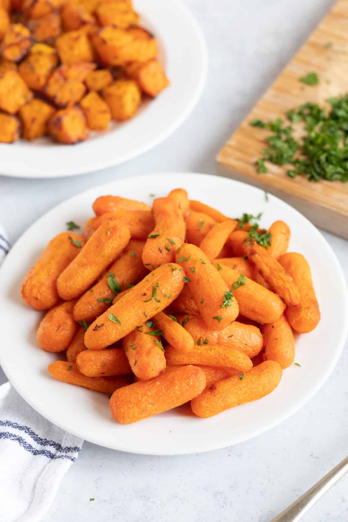 Air fried baby carrots on a plate.