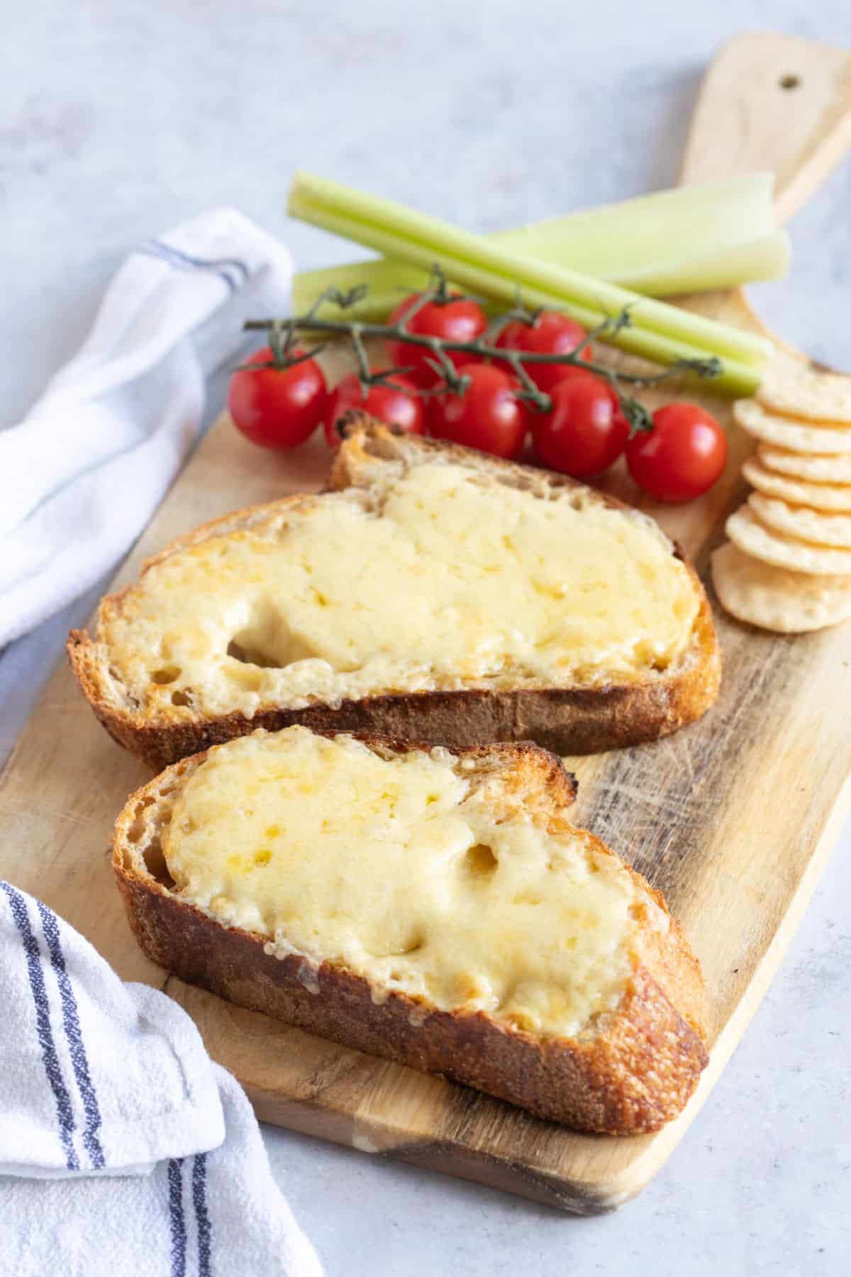 Cheese on toast with celery and tomatoes.