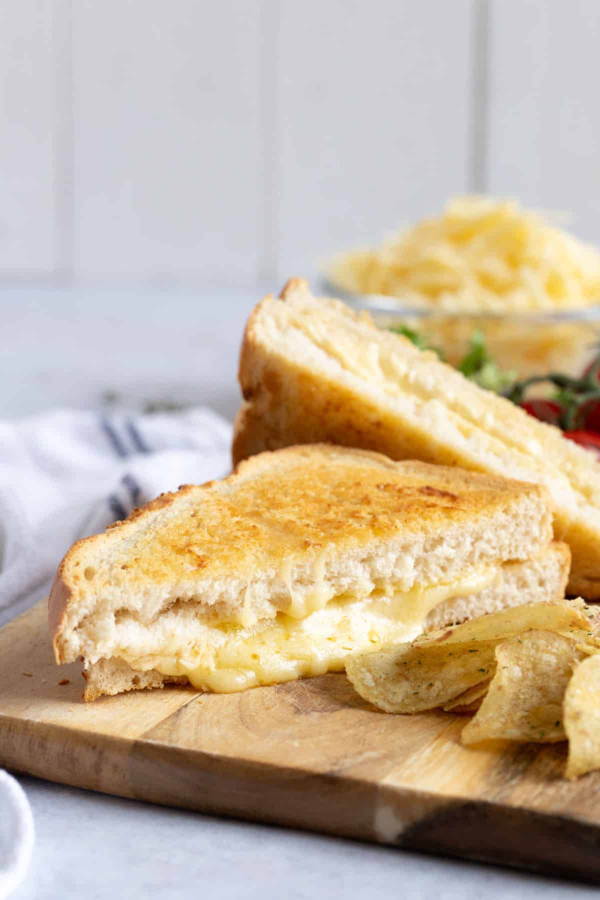 Air fryer toasted cheese sandwich on a wooden board.