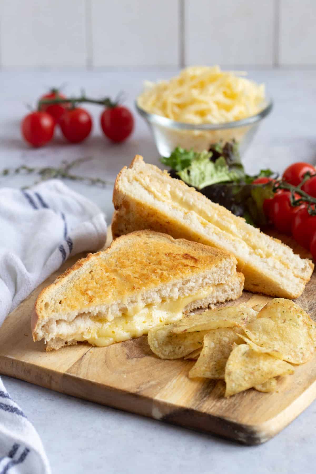 Air fryer cheese toastie with tomatoes and crisps.