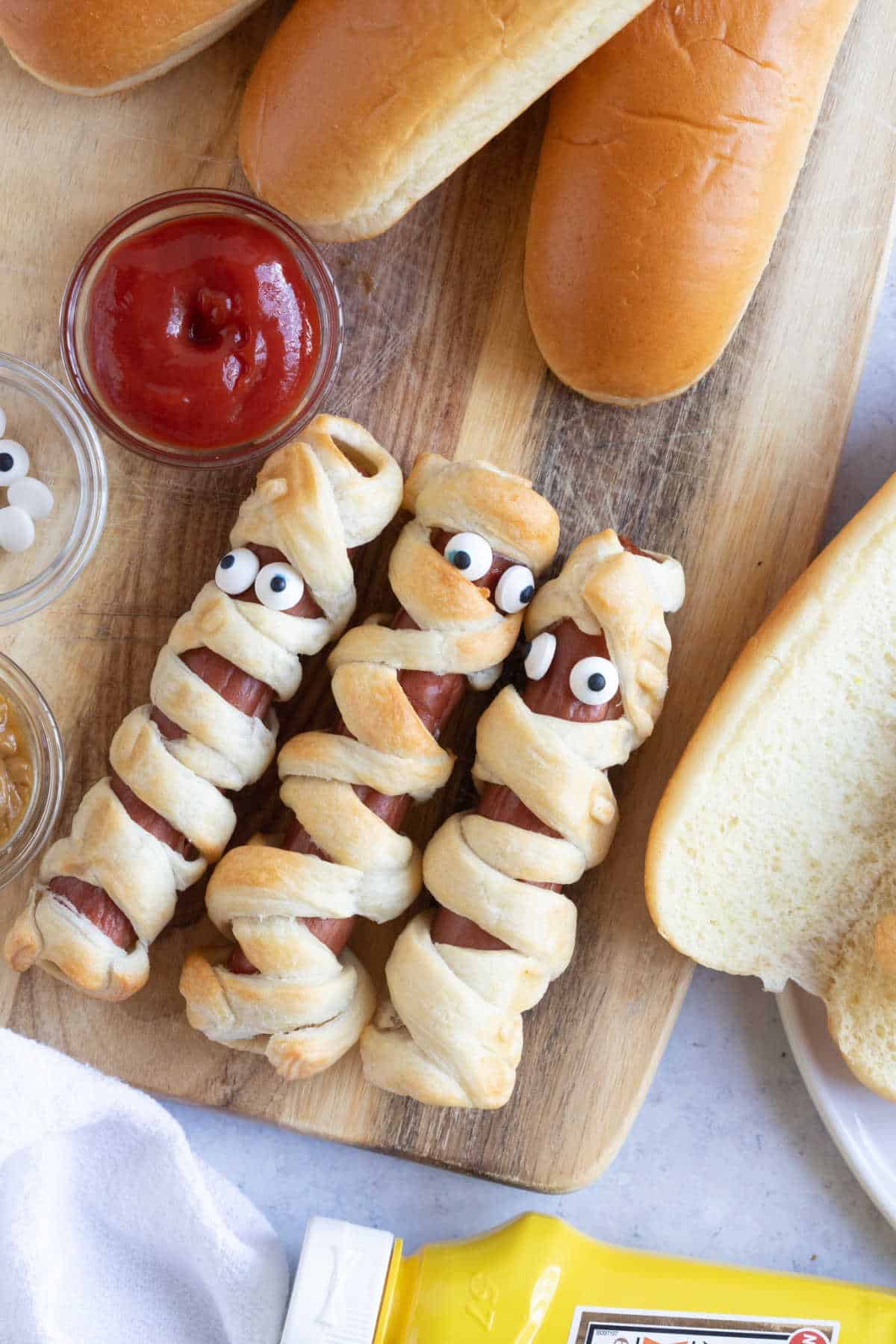 Mummy dogs with ketchup dipping sauce.