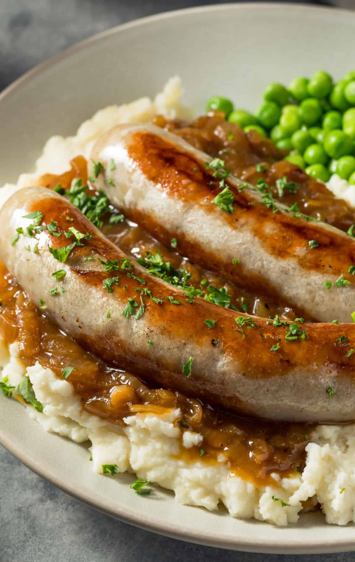Sausages and mash on a plate.