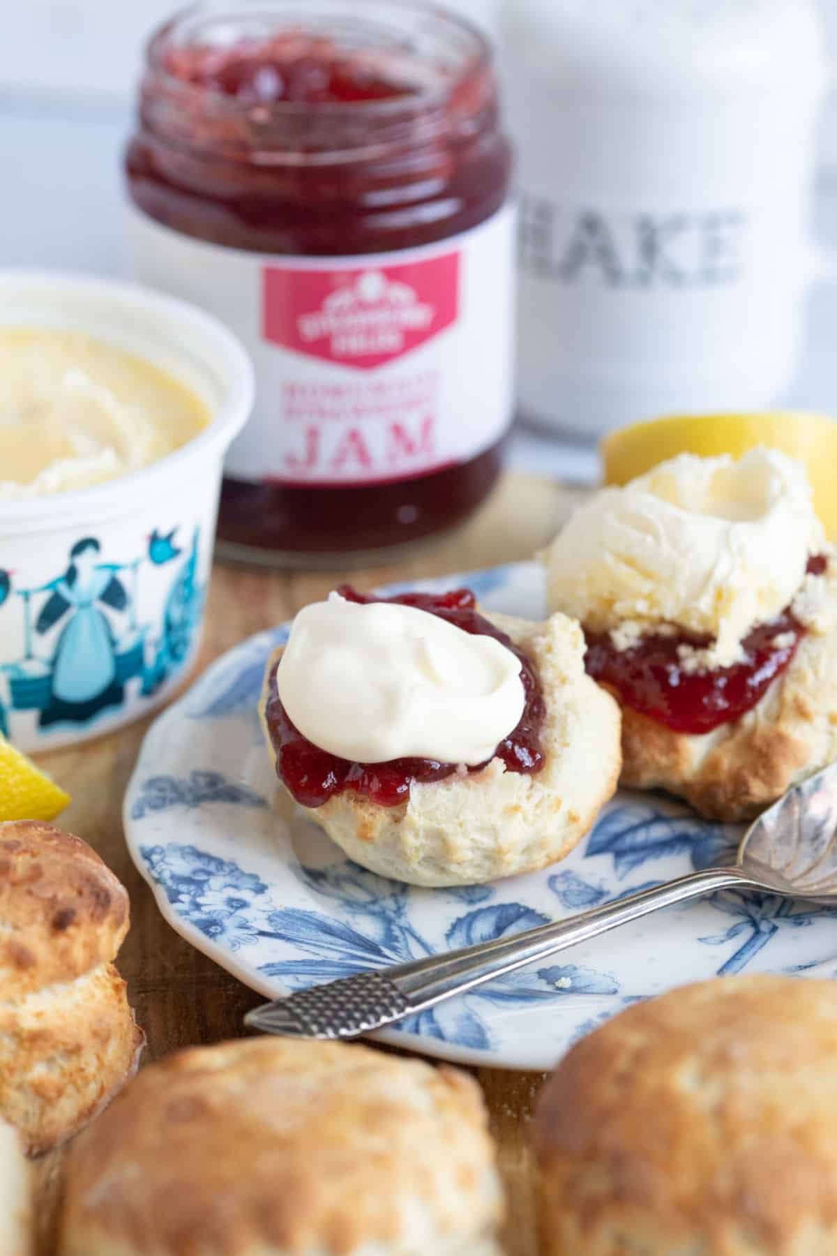 Air fryer scone on a plate with jam and clotted cream.