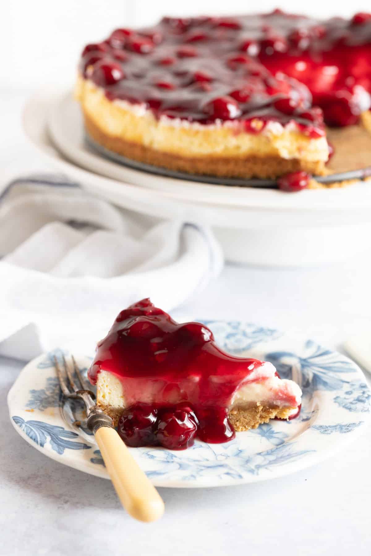 A slice of cherry cheesecake on a plate.