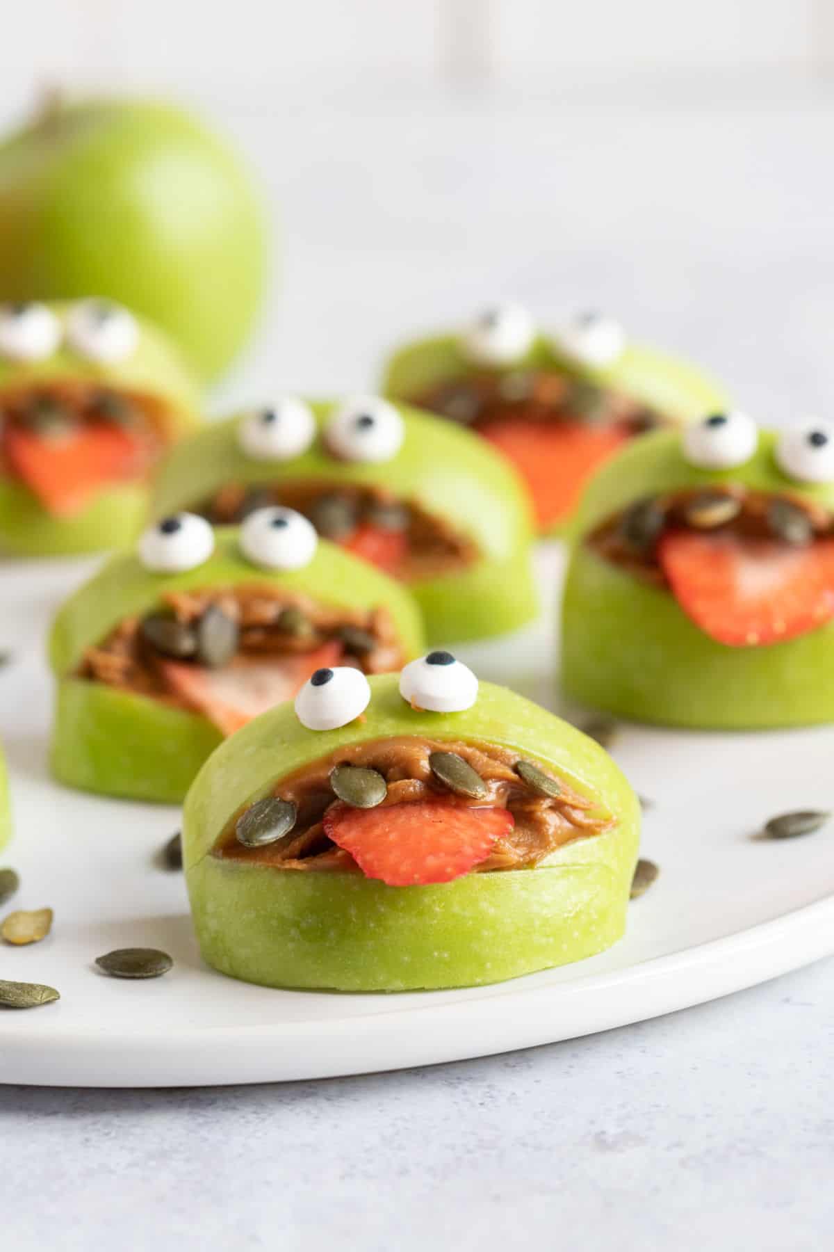 Green apple monsters on a platter.