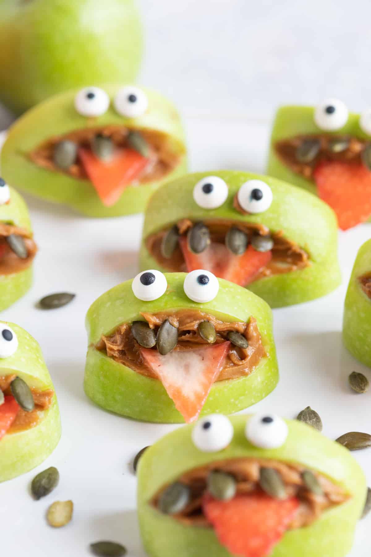 Green apple monsters on a white plate.