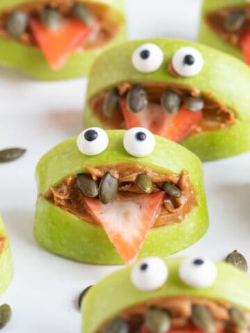 Green apples monsters on a white plate.