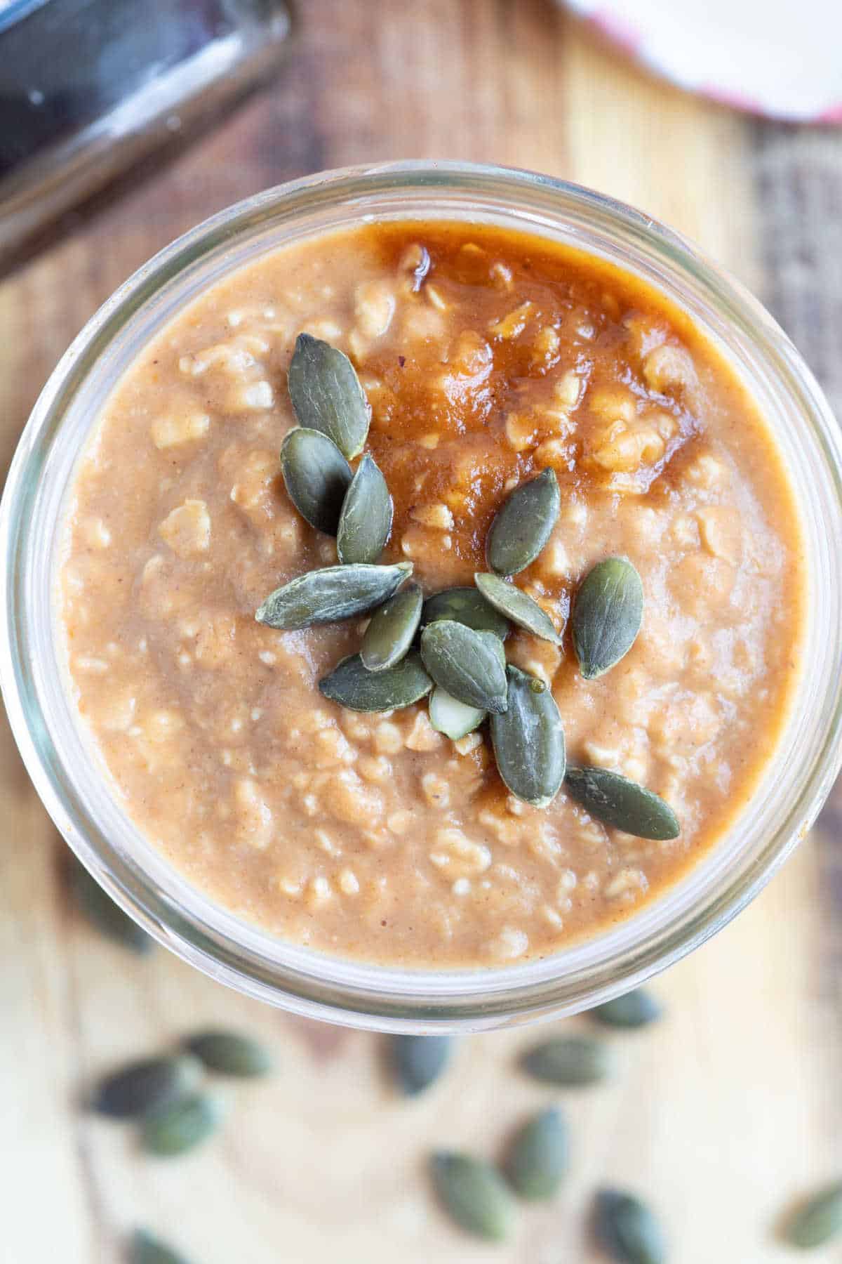 Pumpkin pie overnight oats with pumpkin seeds on top.