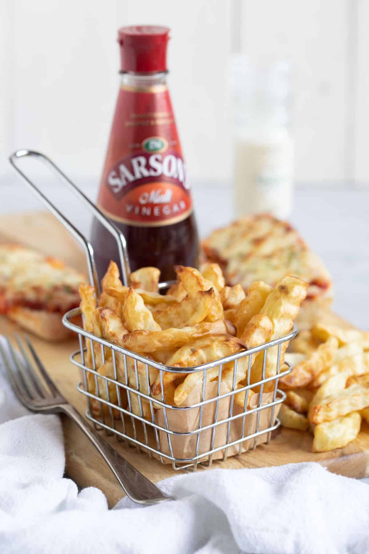 Air fryer chips in a wire basket.