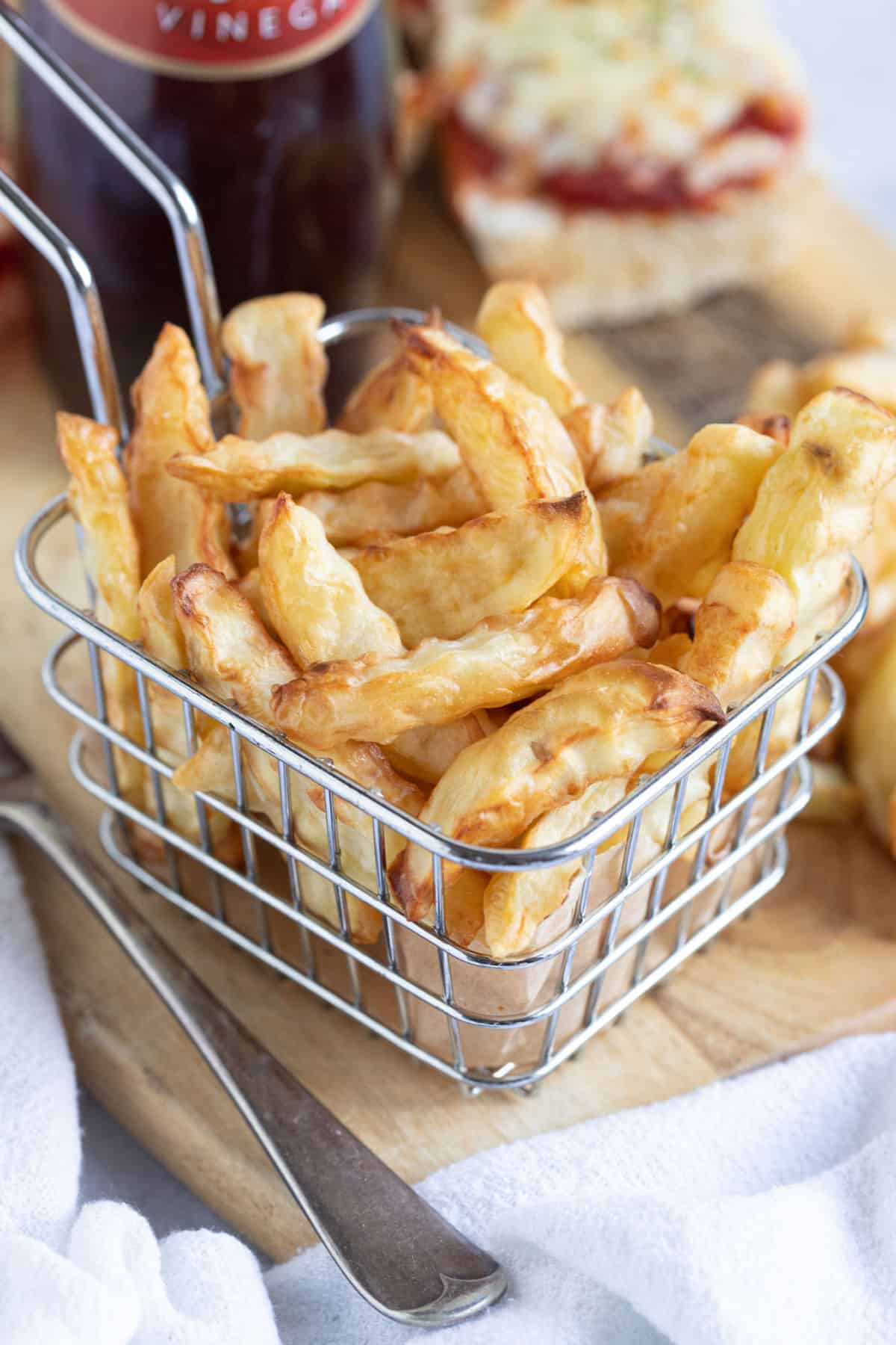 Air fryer chips in a wire basket.