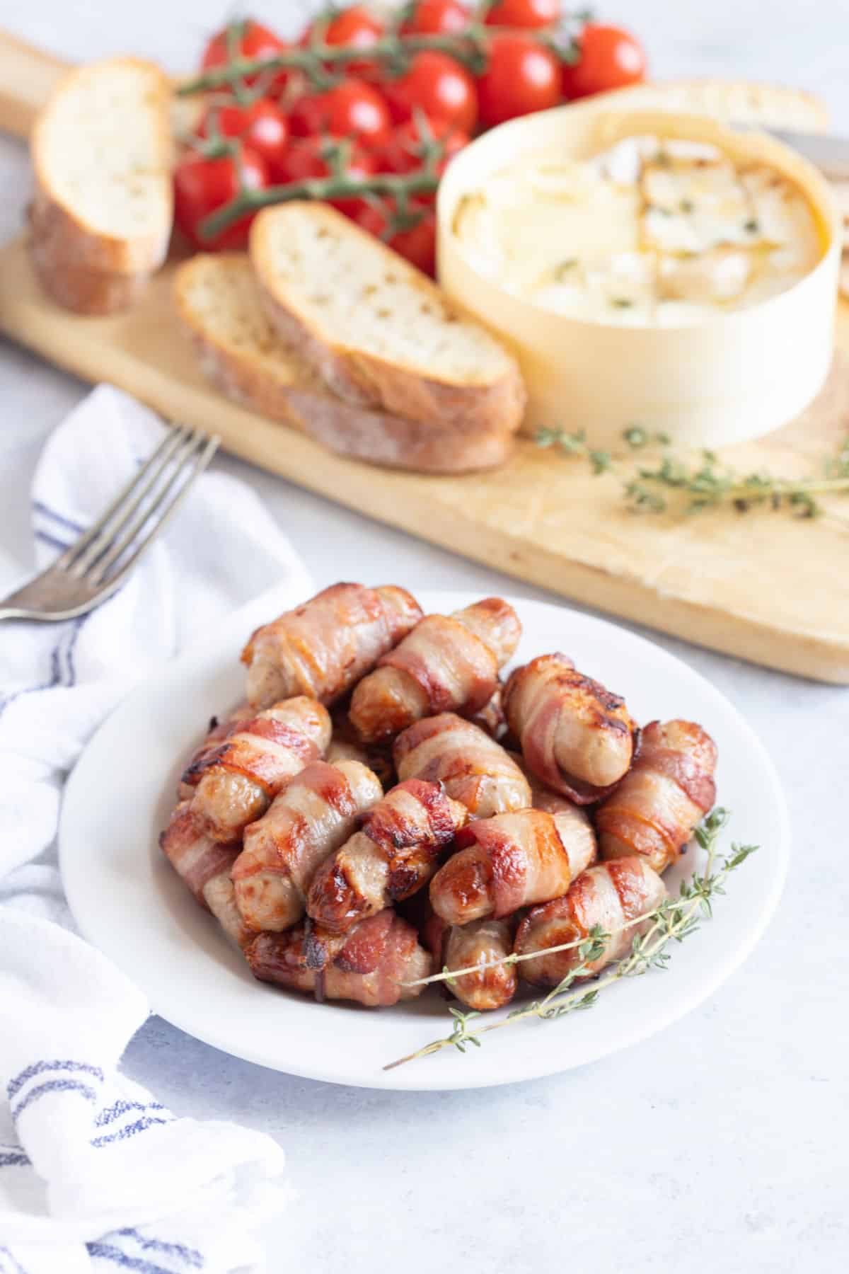 Pigs in blankets on a plate.