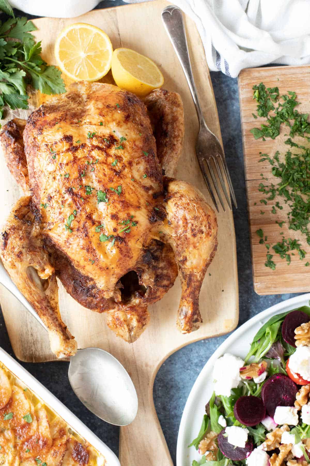 Roast chicken on a wooden board.