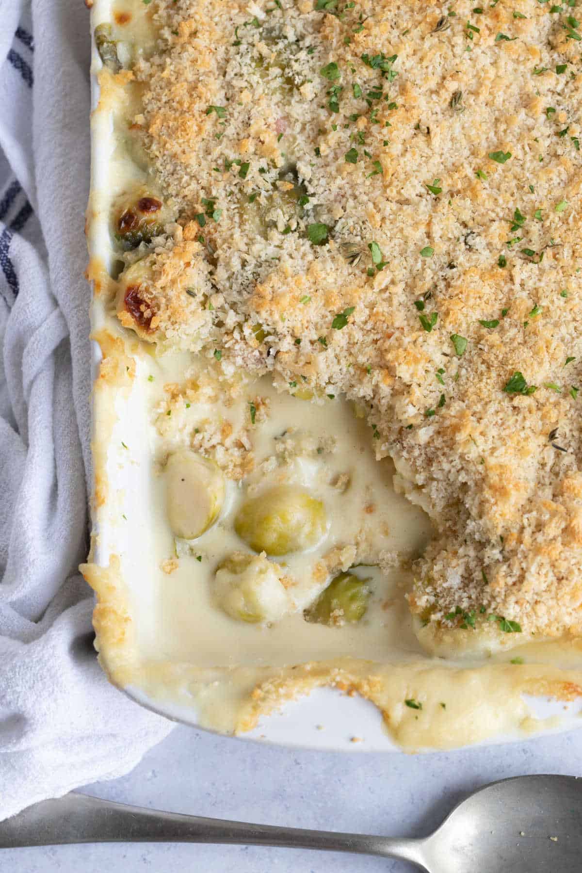 Brussels sprouts gratin in a white baking dish.