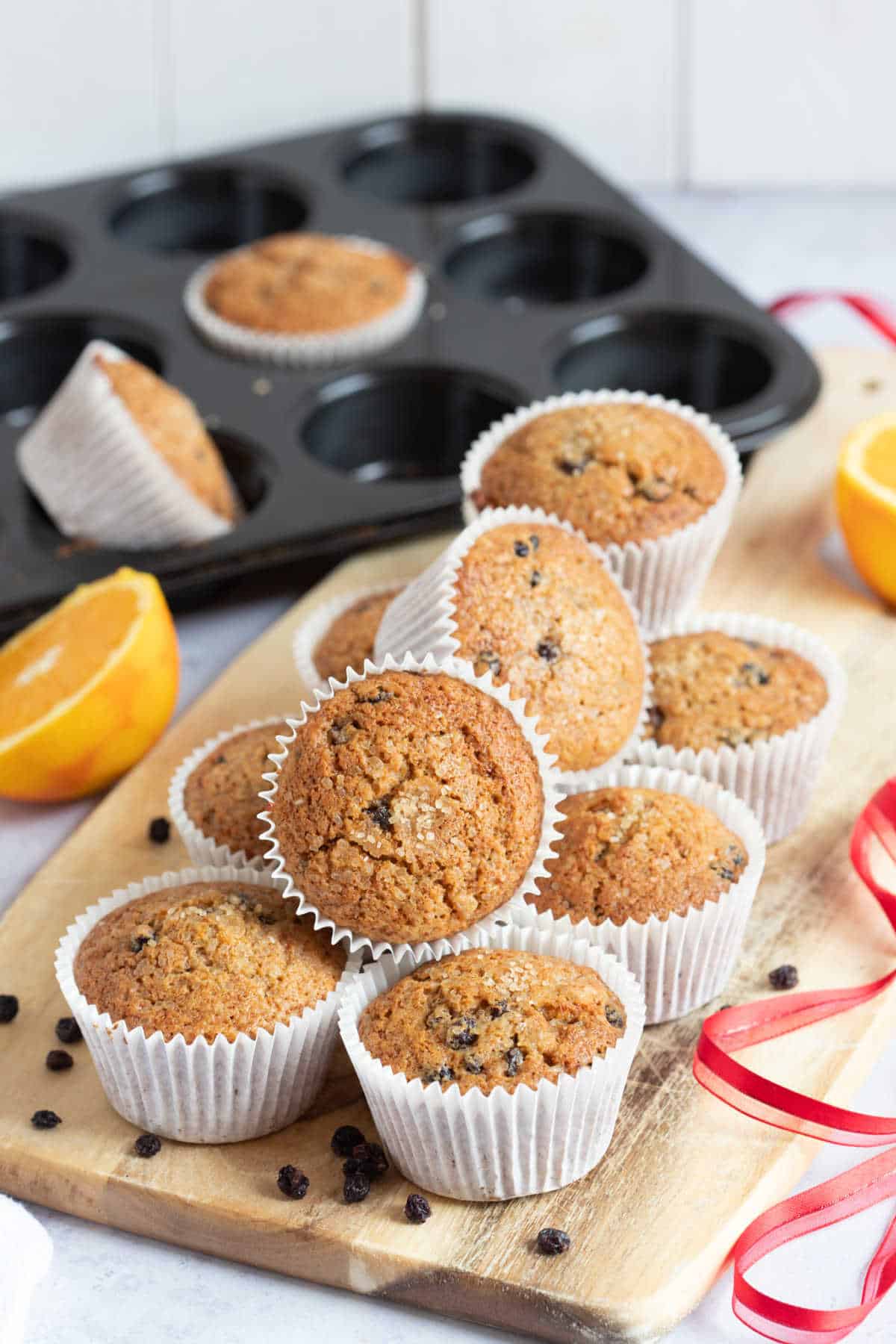 A stack of Christmas cake muffins on a wooden board.