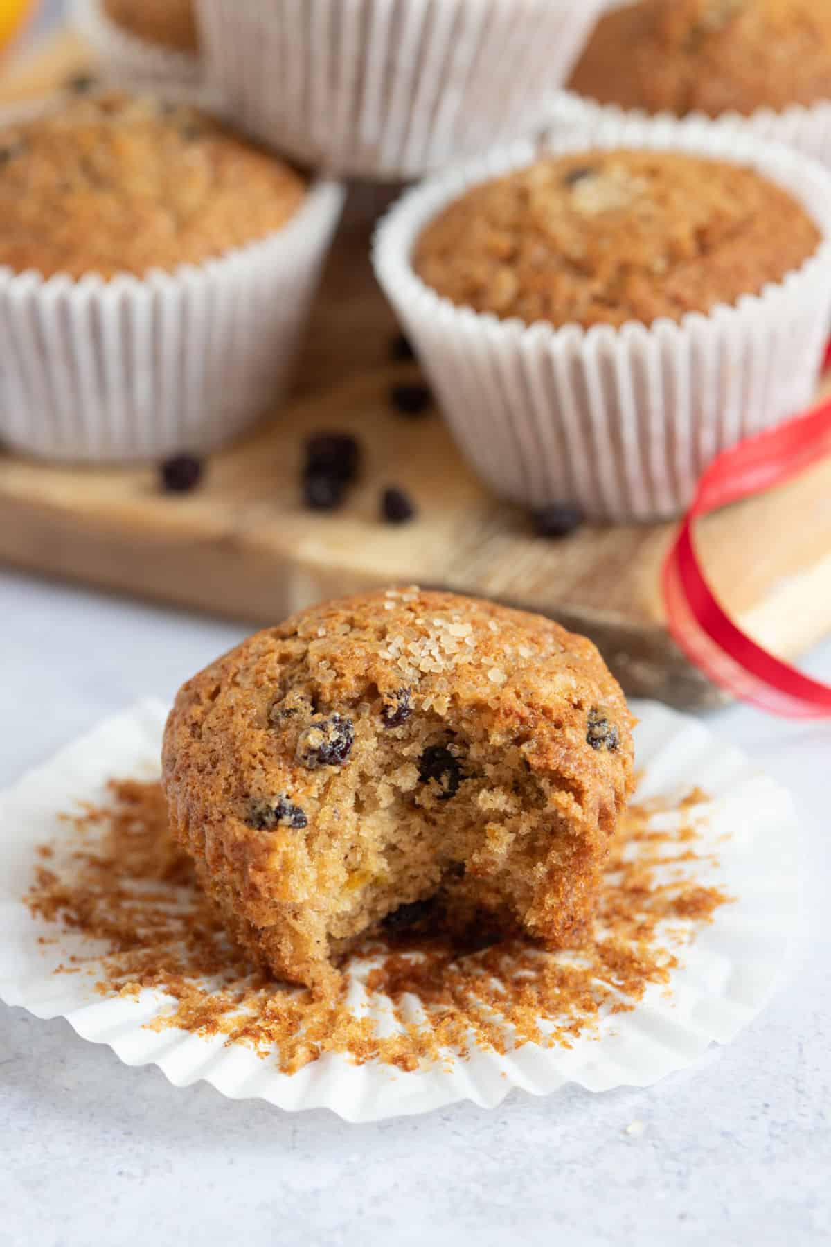 A half eaten Christmas fruit cake muffin.