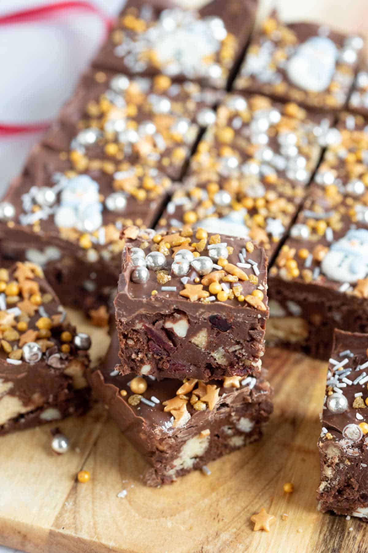 Christmas tiffin cut into slices with Christmas sprinkles on top.